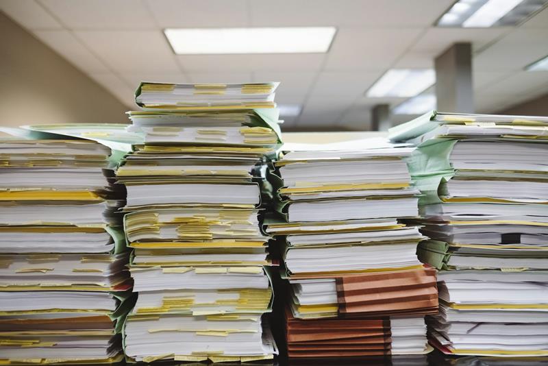 Stacks of paper files and folders in an office